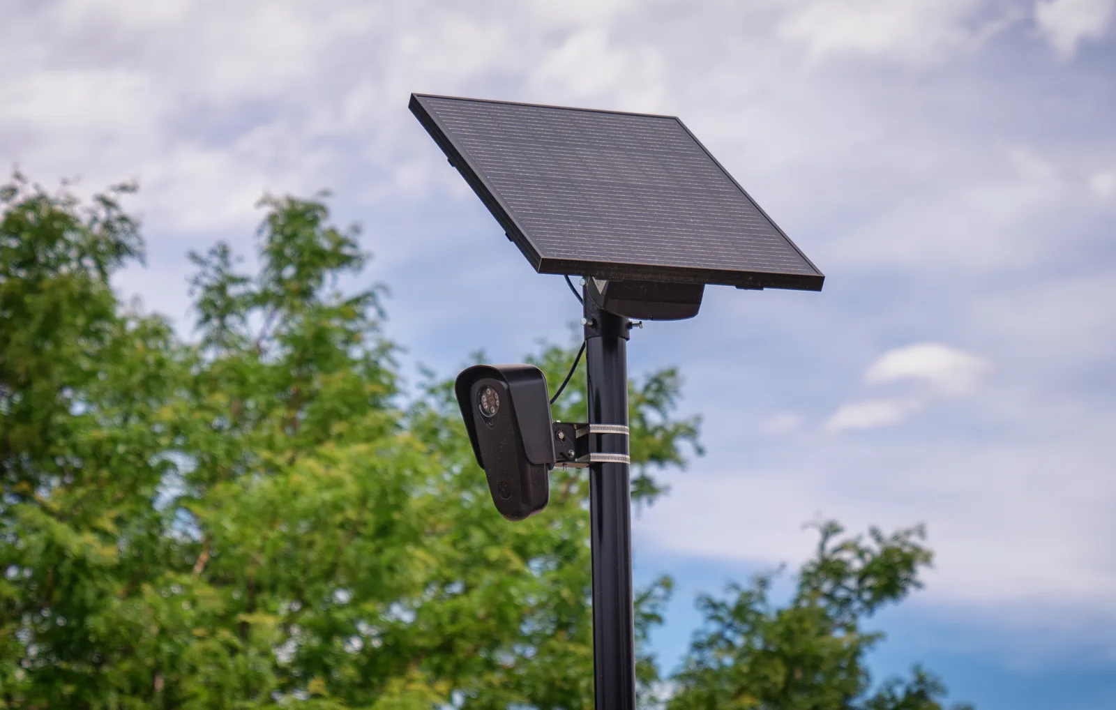 A Flock Safety license plate reader camera on a pole outside a store in Aurora, Colorado. The picture does not show a camera in Apex.