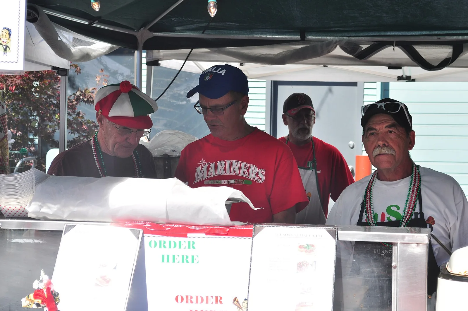 Volunteers serve food at the Sons of Italy booth during the San Gennaro Festival in Seattle's Georgetown neighborhood.