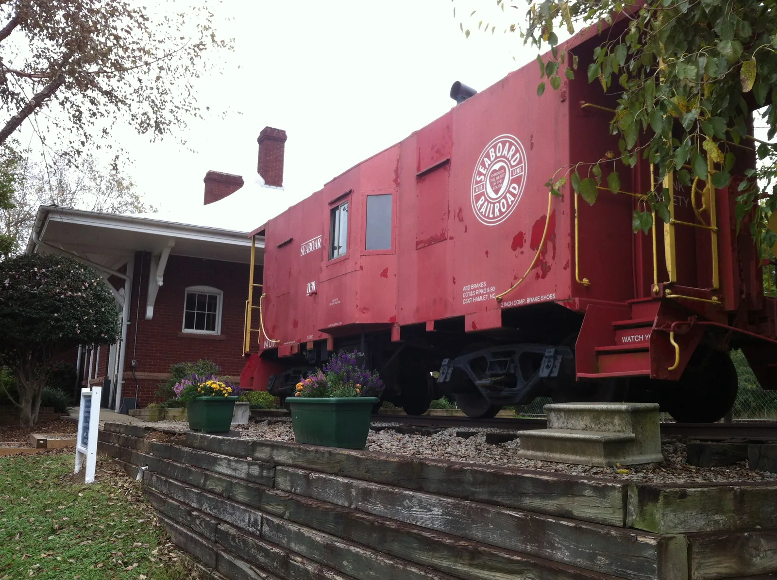 The red Seaboard Air Line Railroad caboose beside the Apex Union Depot on North Salem Street, used as a small railroad museum.