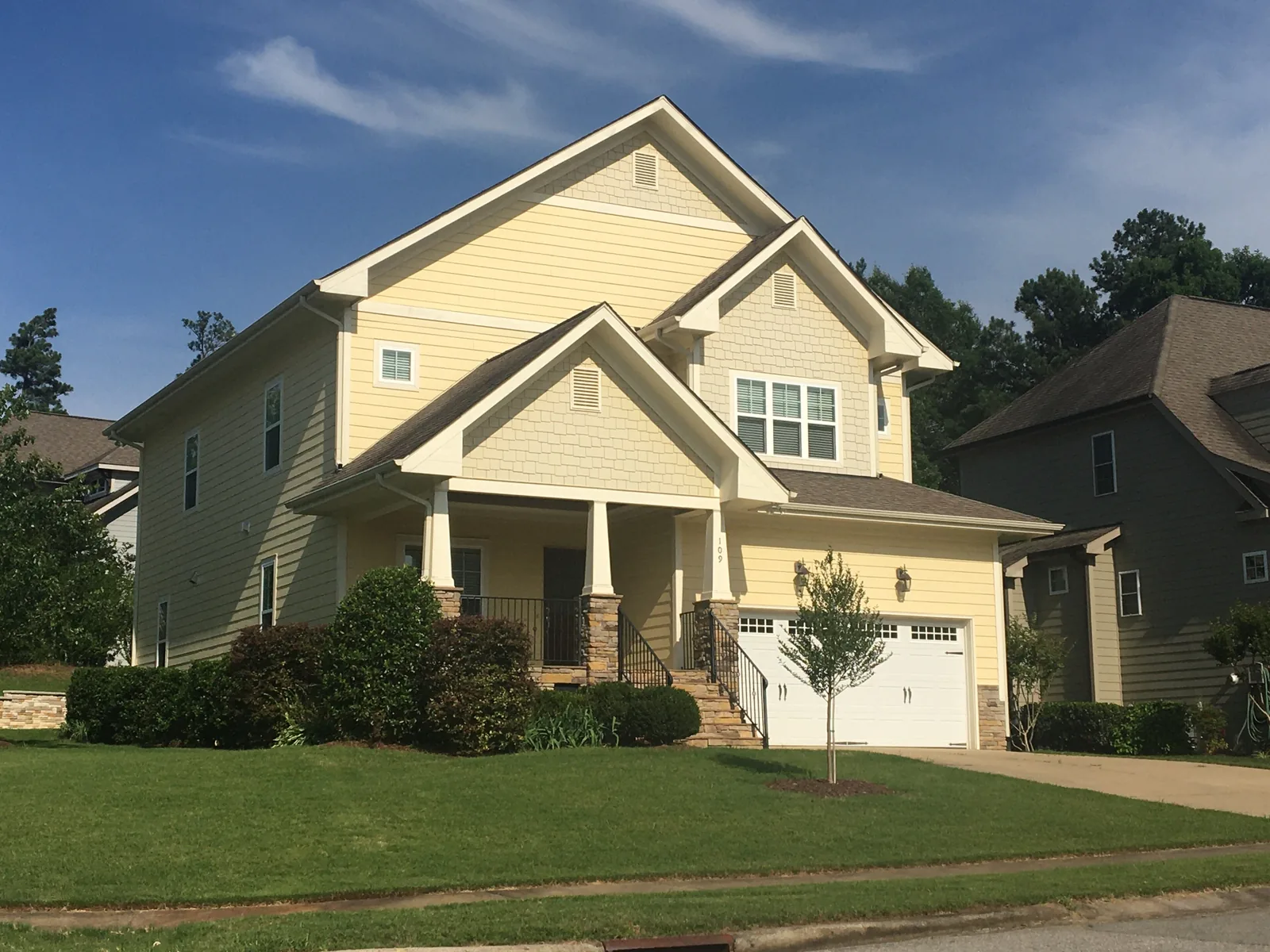 A two-story house with a front porch and two-car garage in Holly Springs, about five miles south of Apex.