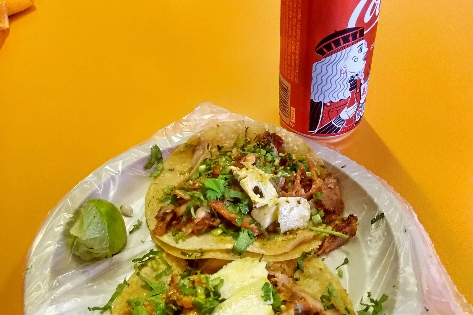 Tacos al pastor on a plate at a taqueria in Mexico City. The photo was not taken in Apex.