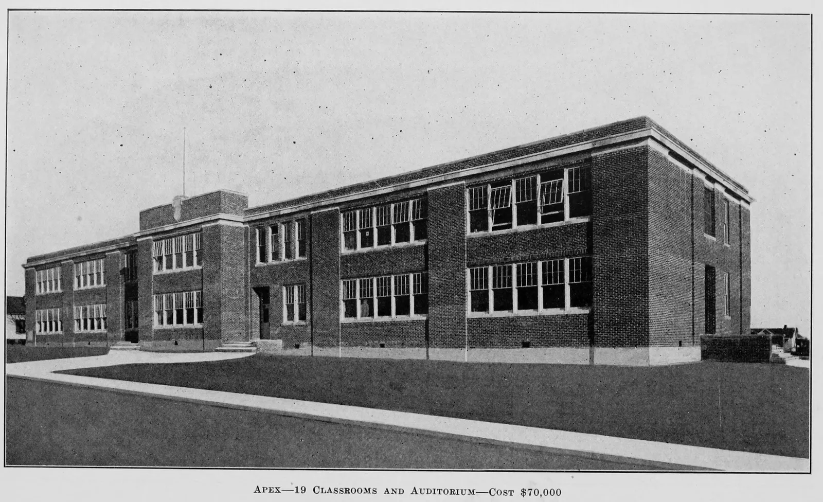 The brick Apex school, with 19 classrooms and an auditorium, in a photograph from a North Carolina state school report