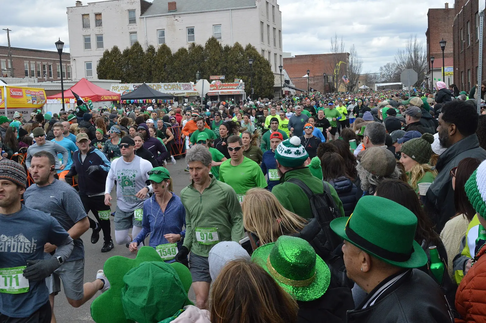 Runners leave the starting line of a 10K road race on Maple Street in Holyoke, Massachusetts.