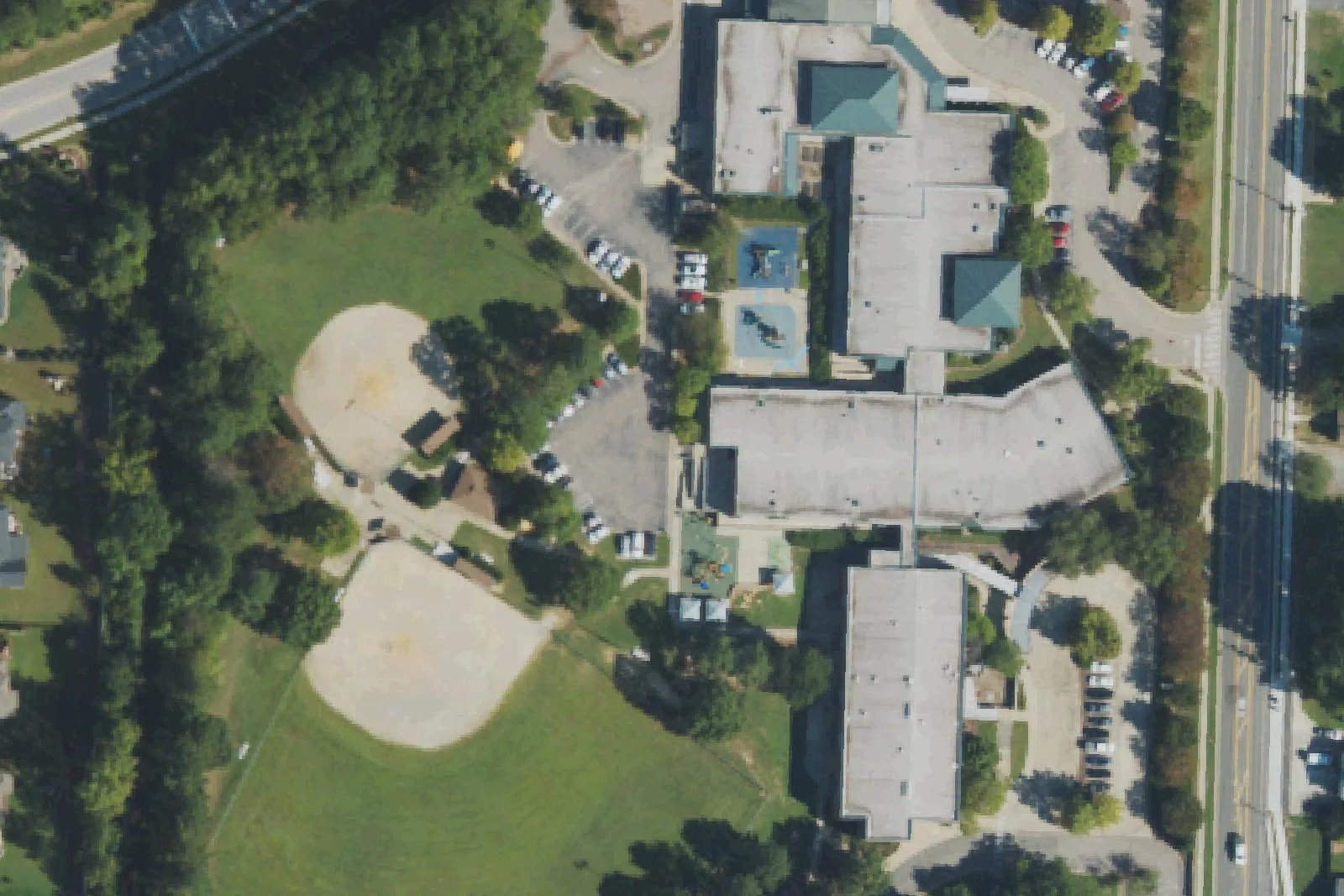 Apex Elementary School's buildings and ball field on Tingen Road in Apex, seen from the air