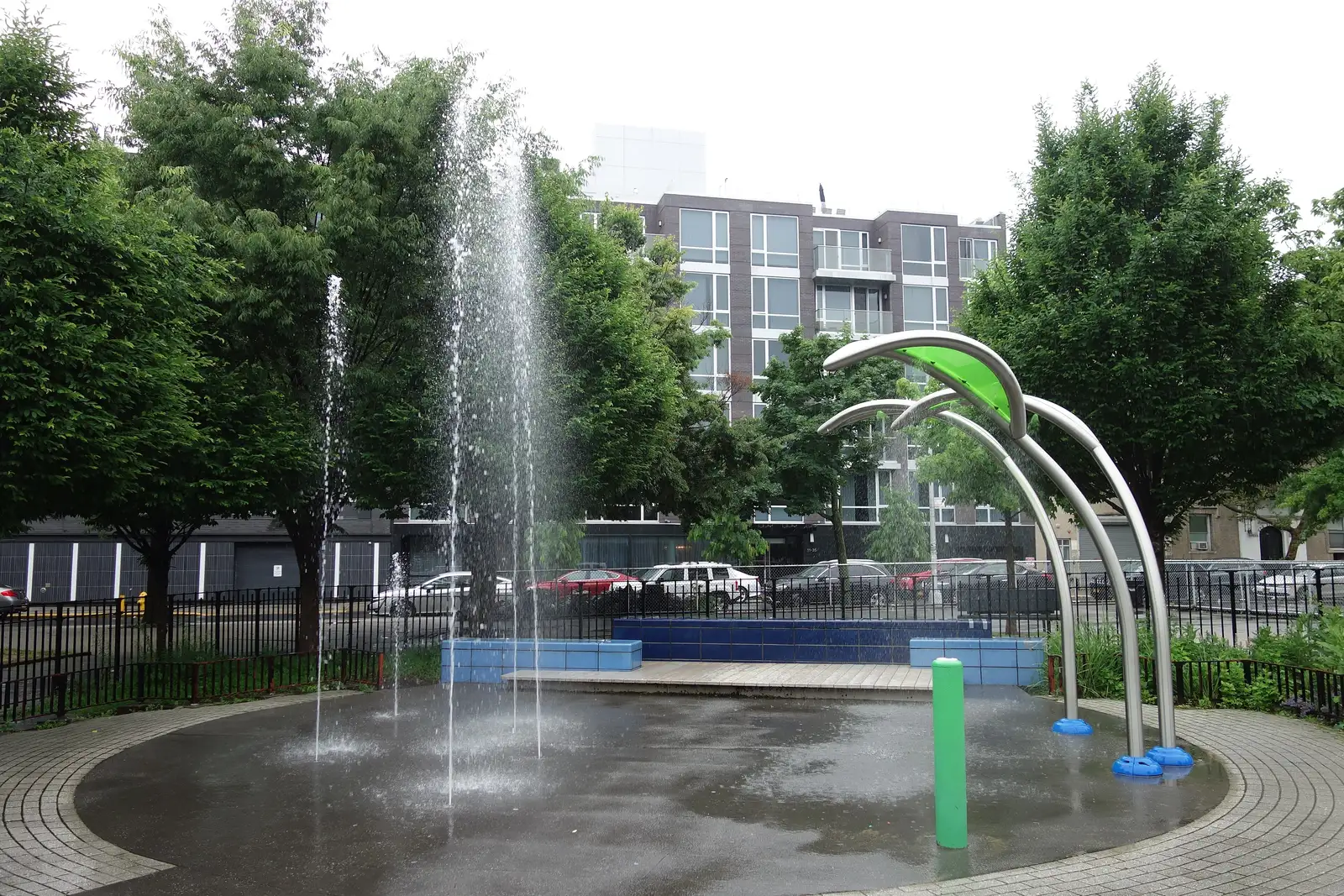 Water jets spray across the splash pad at Murray Playground in Long Island City, Queens, New York.