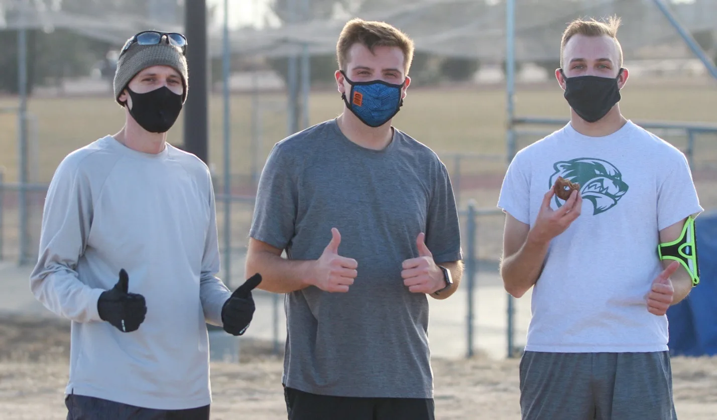 Runners give a thumbs-up after finishing a Thanksgiving-week Turkey Trot race in Colorado.